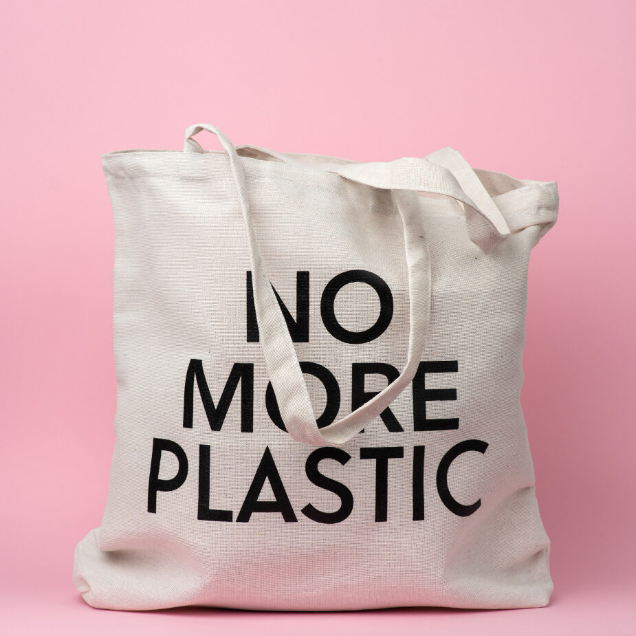 beige-textile-bag-with-inscription-no-more-plastic-pink-background-no-plastic